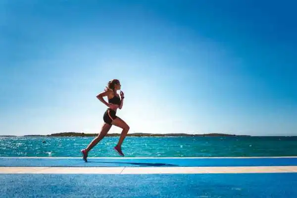 Woman running showing strong leg muscle St Neots